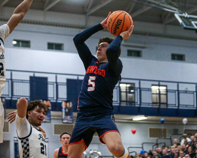 Oswego's Mariano Velasco (5) puts up a shot at the basket during their basketball game between Oswego at Oswego East, Feb 13, 2026 in Oswego.
