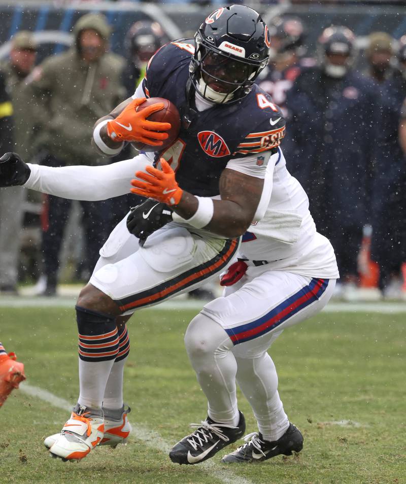 Chicago Bears running back D'Andre Swift tries to escape a New York Giants defender Sunday, Nov. 9, 2025, during their game at Soldier Field in Chicago.