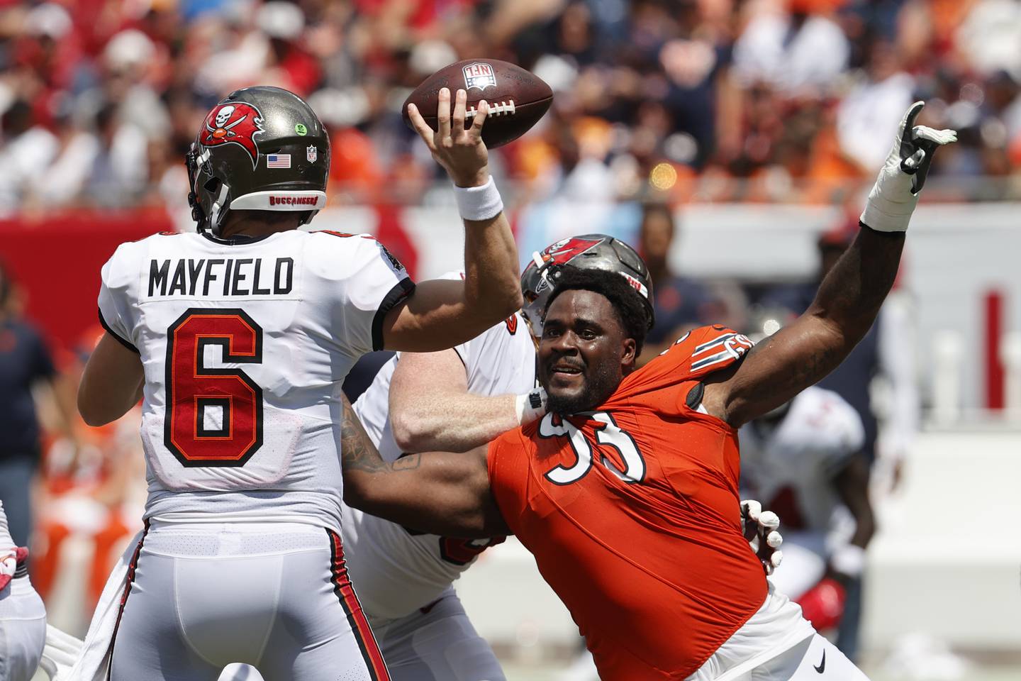 Chicago Bears defensive tackle Justin Jones is held back by Tampa Bay Buccaneers guard Cody Mauch (as Jones tries to stop a pass by Tampa Bay Buccaneers quarterback Baker Mayfield during the first half, Sunday, Sept. 17, 2023, in Tampa, Fla.