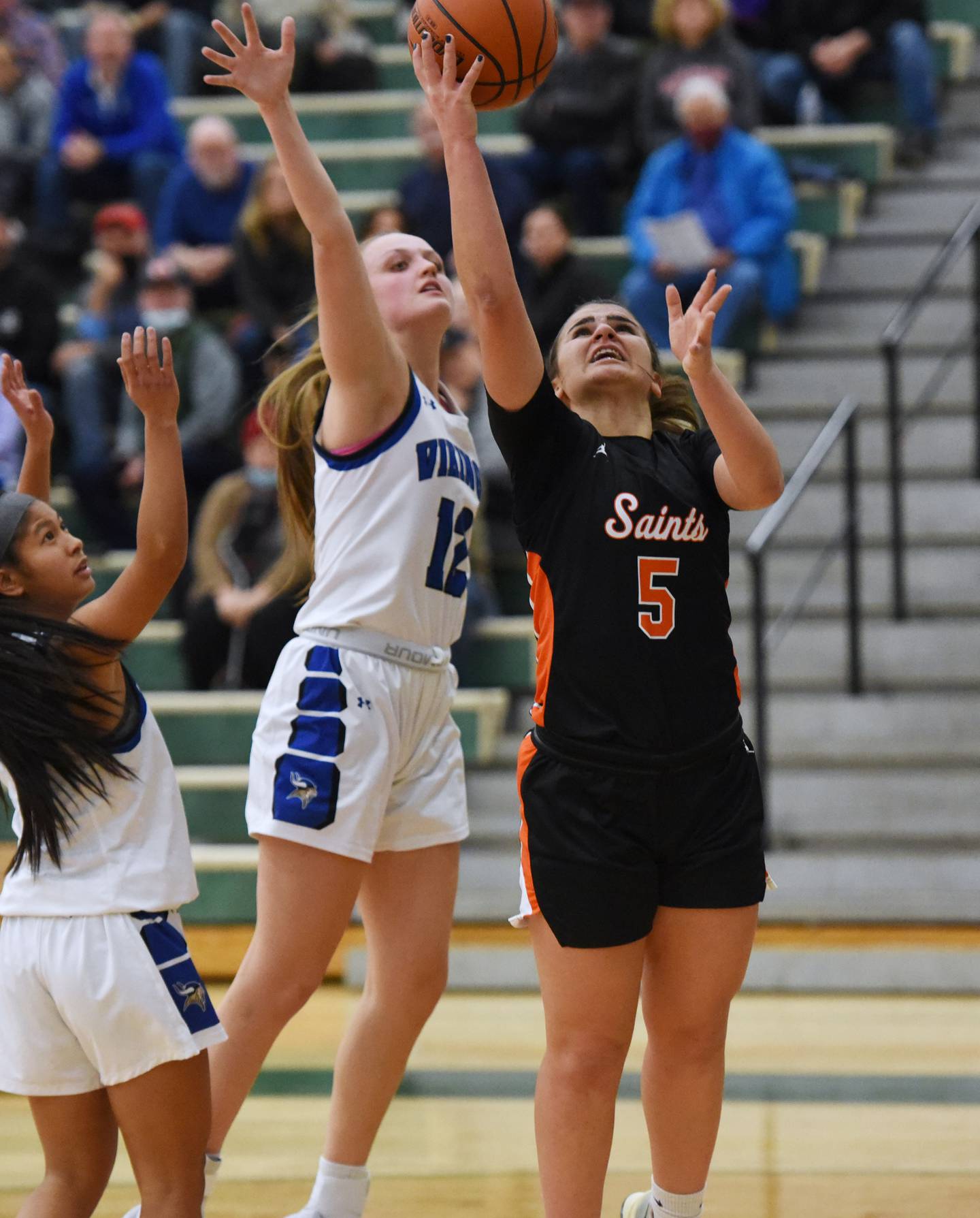 St. Charles East's Lexi Diorio (5) takes a shot past Geneva's Zosia Wrobel during TuesdayÕs Class 4A sectional semifinal girls basketball game in Bartlett.