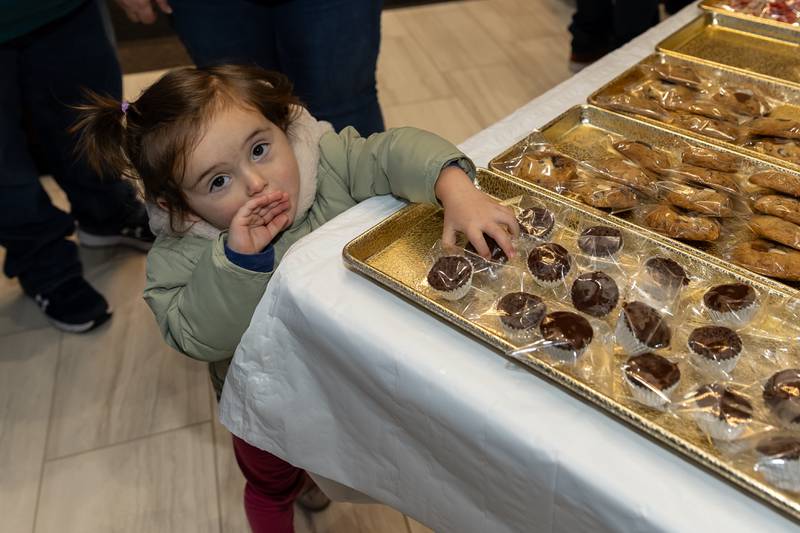 Crest Hill resident Amelia Simpson picks-up a treat from Kafe De Kasa during Winterfest at Crest Hill City Center on Nov. 30, 2024.