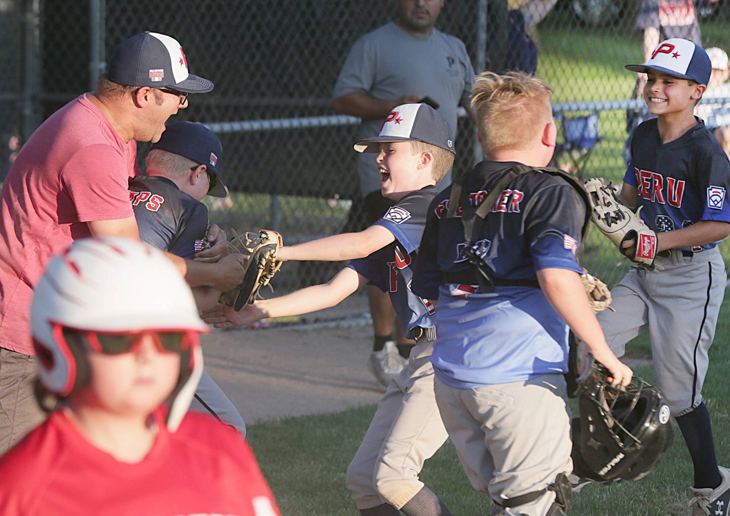 Members of the Peru All-Star team celebrate after defeating Streator in the 10-Year-Old District 20 championship game on Wednesday, July 13, 2022, at Jim Bottomley Field in Oglesby.