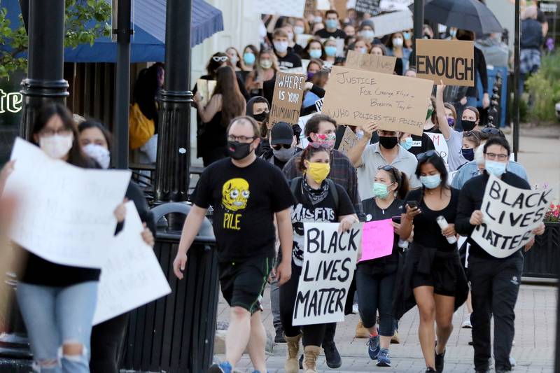 Hundreds of protesters rally against social injustices faced by African-American communities across the country during a Black Lives Matter protest, sparked by the death of George Floyd, on the historic Woodstock Square on Sunday, May 31, 2020 in Woodstock.