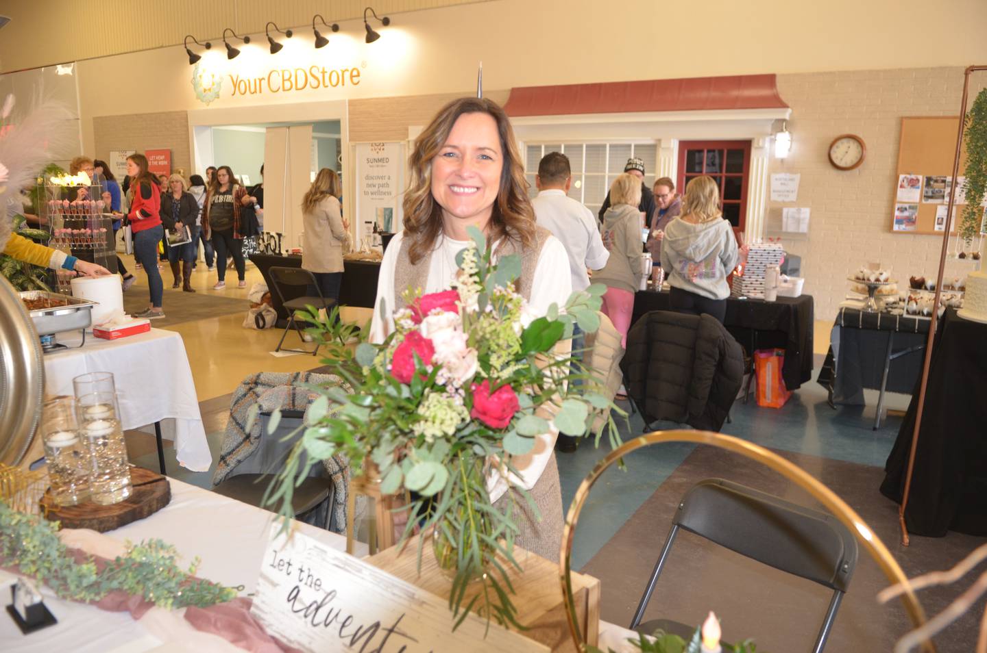 Amy Misfeldt, of Prophetstown, is shown at her booth for her floral designing business, Blooms a latte, on Sunday at Northland Mall in Sterling.