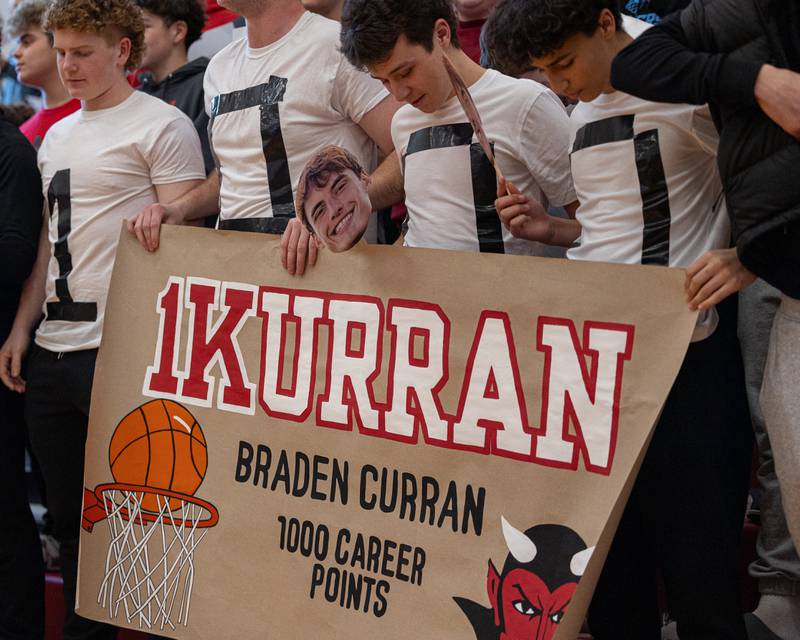 Hall students hold sign honoring Braden Curran (33) of Hall scoring 1,000th career points Saturday, January 31, 2026 at Hall High School in Spring Valley.