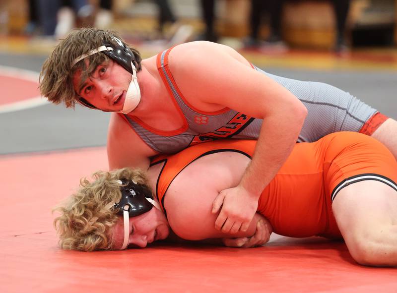 Minooka's Hunter Coons, in orange, wrestles Yorkville's Hunter Janeczko, in grey, during the Southwest Prairie Conference wrestling meet at Yorkville High School on Saturday, Jan. 21, 2023.
