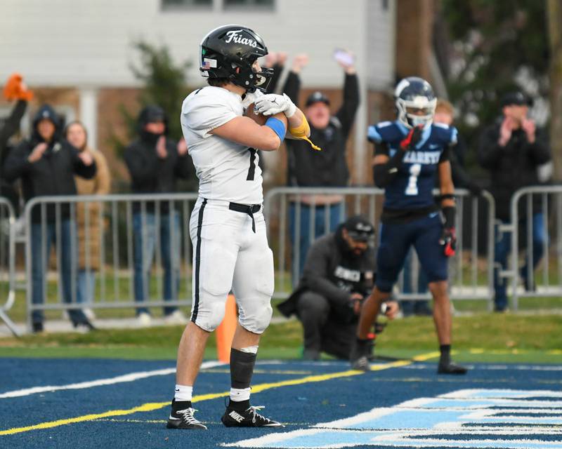 Fenwick's Tommy Thies (7) holds the ball in the endzone after scoring a touchdown in overtime in the 6A semifinals game while taking on Nazareth Academy on Saturday Nov. 22, 2025, held at Nazareth Academy High School in La Grange Park.