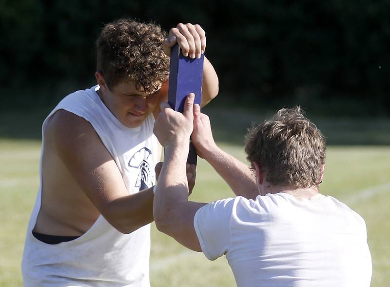 Cary-Grove’s Ethan Maarkee and Gabe Simpson practice their blocking drills during summer football practice Thursday, June 30, 2022, at Cary-Grove High School in Cary.