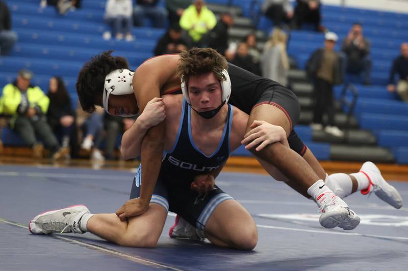 Plainfield South’s Colin Bickett lifts Plainfield North’s Raphael Tovar in a Southwest Prairie dual meet on Wednesday, Nov. 29, 2023 in Plainfield.