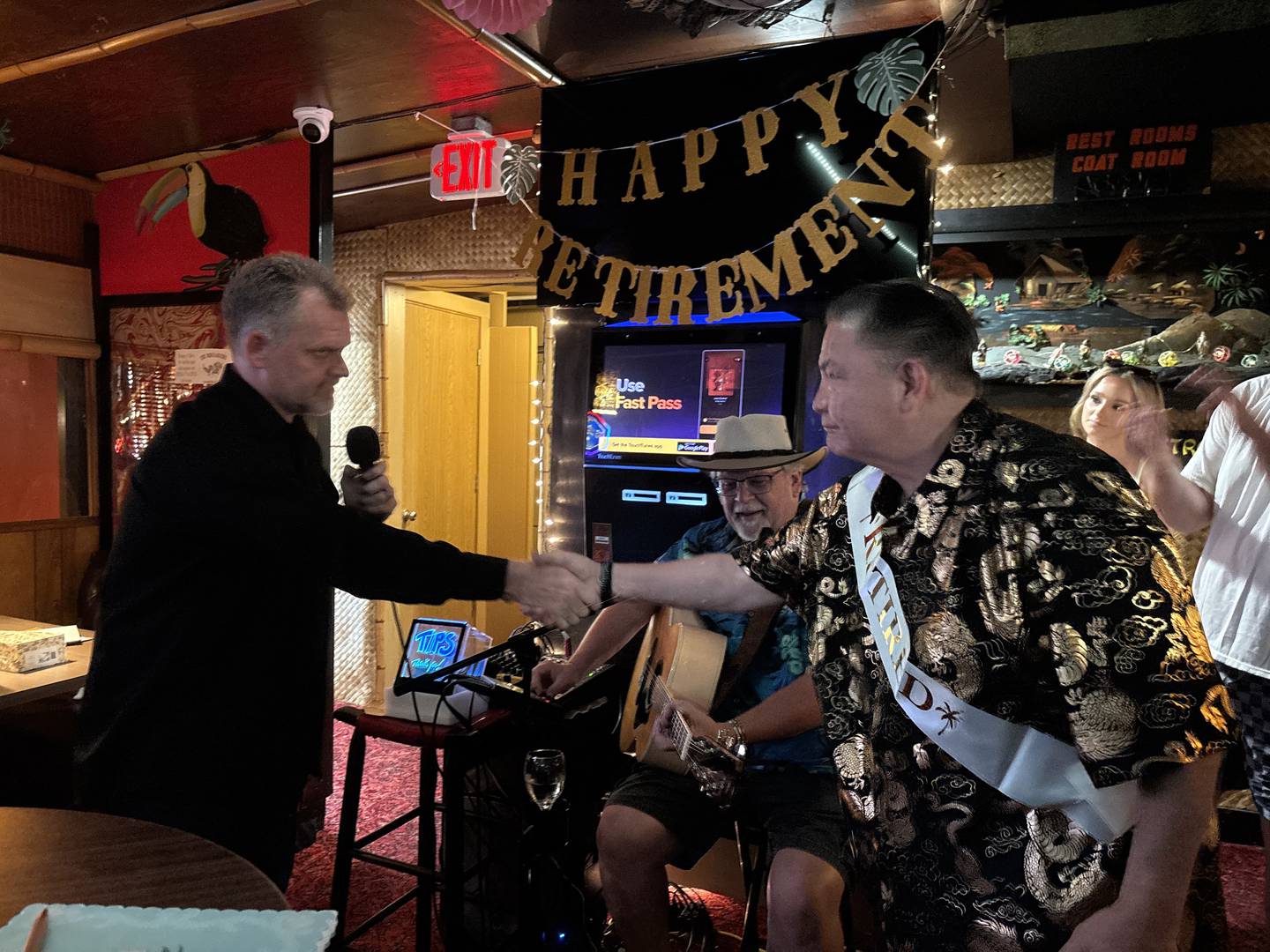 Jason Weisenberger, one of the owners of the Breakers in Crystal Lake, shakes server Danny Kakazu's hand June 29, 2025.