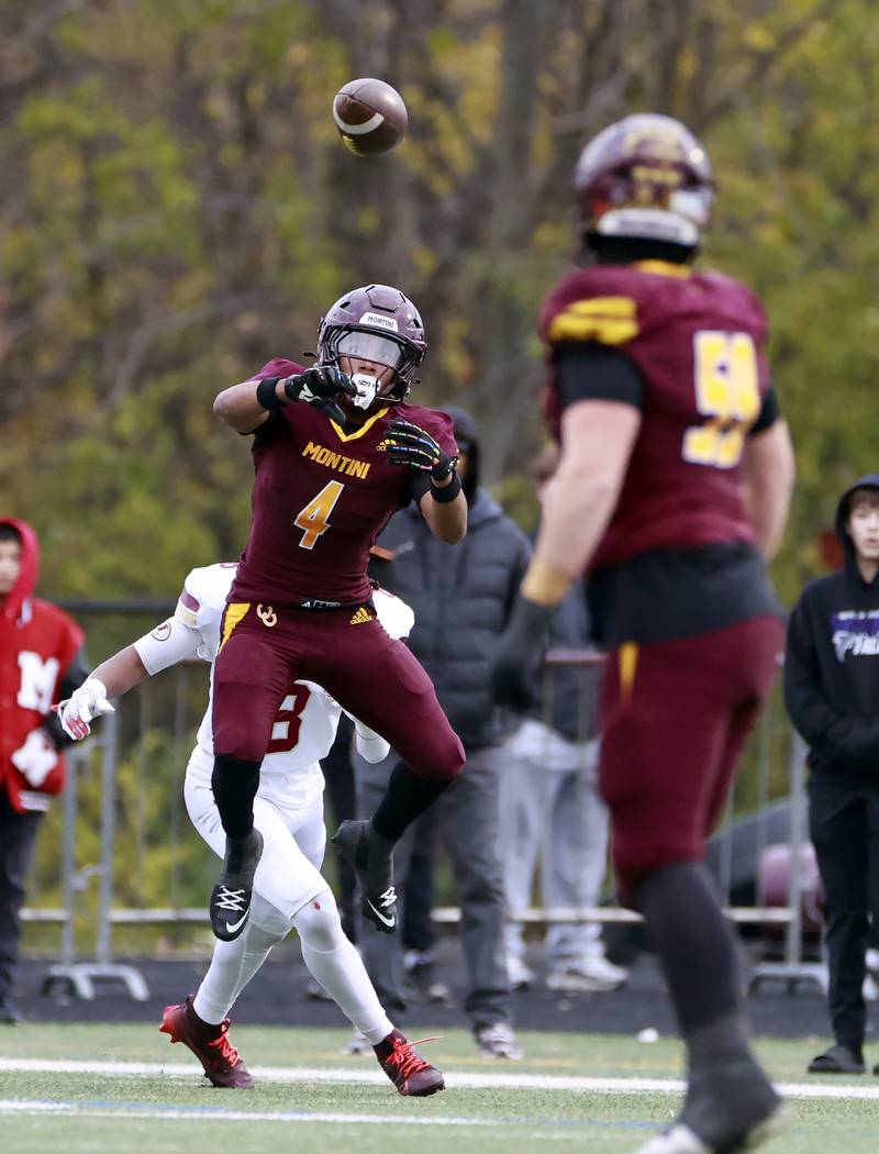 Montini's Damacio Ortegon (4) reels in a pass over Morris' Caleb Walton (8) during the IHSA Class 4A semifinals football playoff game Saturday, Nov. 22, 2025 in Lombard.