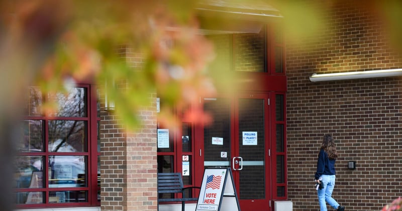 A voter arrives to the polling precinct at the Bradley Public Library on Tuesday morning as rain falls across the area.
