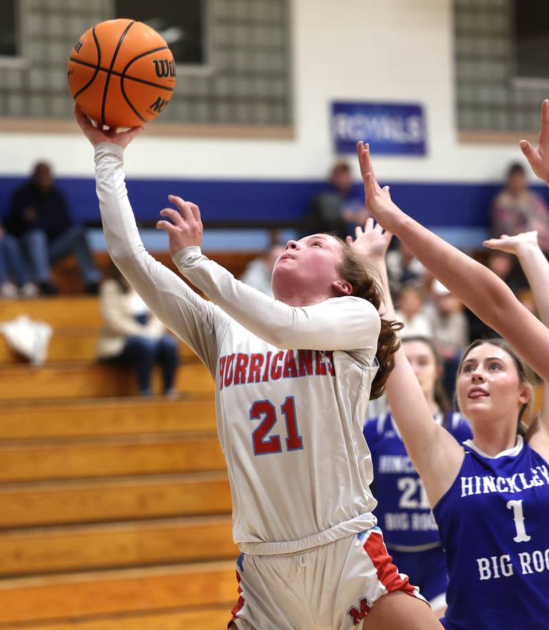 Marian Central's Lainey Remke gets a layup in front of Hinckley-Big Rock's Payton Murphy Monday, Feb. 16, 2026, during their regional semifinal game at Hinckley-Big Rock High School.