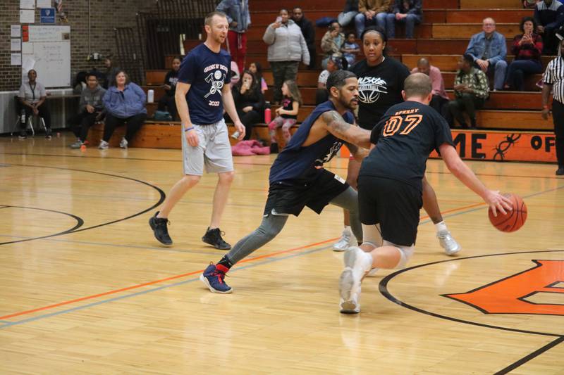 Andrew Sperry (right) fends-off a defender Monday, Dec. 5, 2022 in the Toys for Tots community basketball game.