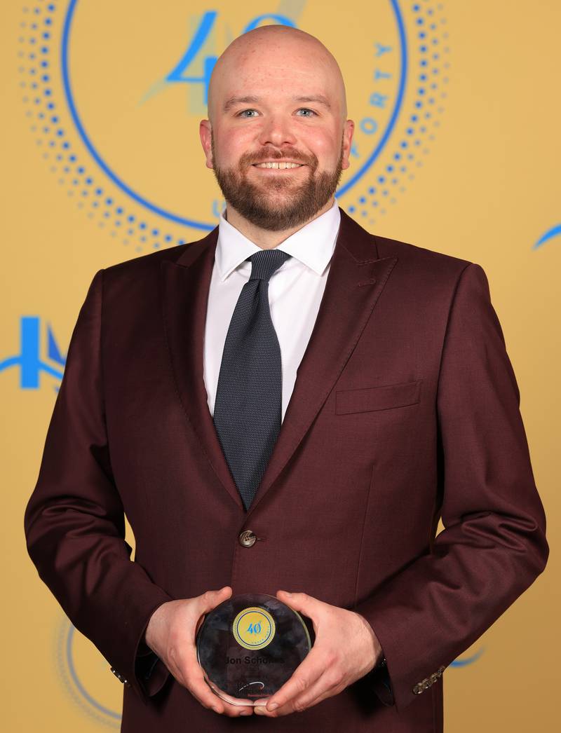 John Scholtes poses with his 40 Under Forty award during the Illinois Valley Chamber of Commerce Champions of Change Awards Night on Thursday, April 10, 2025 at the Westclox Event Center in Peru.