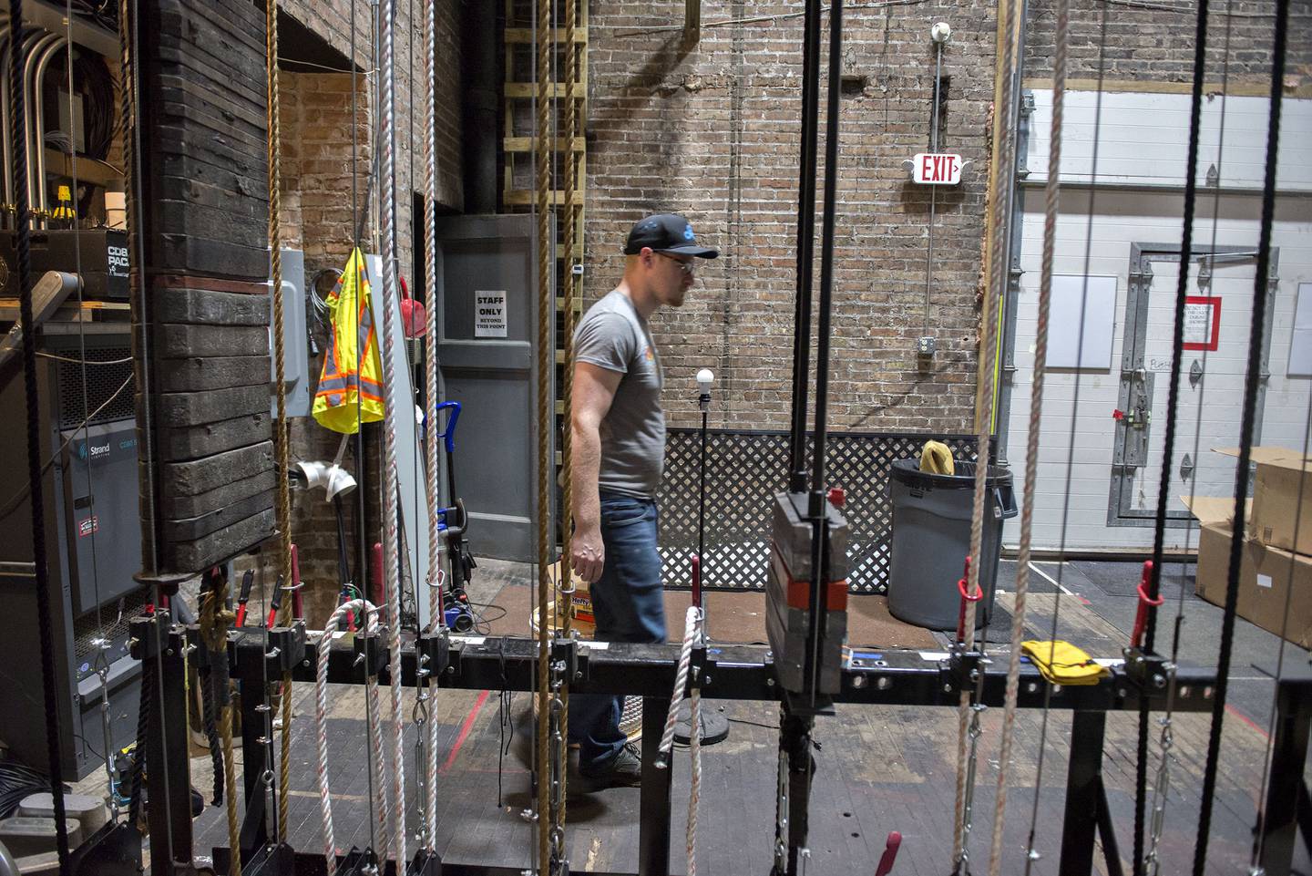 Spencer Aurand, facility manager and technician, moves past controls for the new fly system that will allow lights and scenery to raised and lowered efficiently.