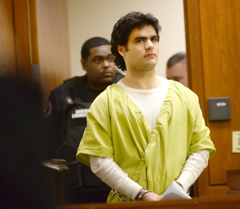 Jonathan Gounaris is escorted into a courtroom at the Ogle County Judicial Center in Oregon by a Winnebago County Corrections Officer on Monday, April 28, 2025. He is charged with shooting three Ogle County  police officers during an incident at his home in rural Dixon in June 2024. He is being held in the Winnebago County Jail as his attempted murder case proceeds through the court system.