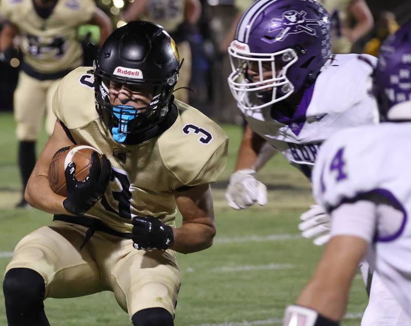 Sycamore's Benjamin Anderson braces for contact from Rochelle's Dylan Manning after a reception during their game Friday, Sept. 19, 2025, at Sycamore High School.
