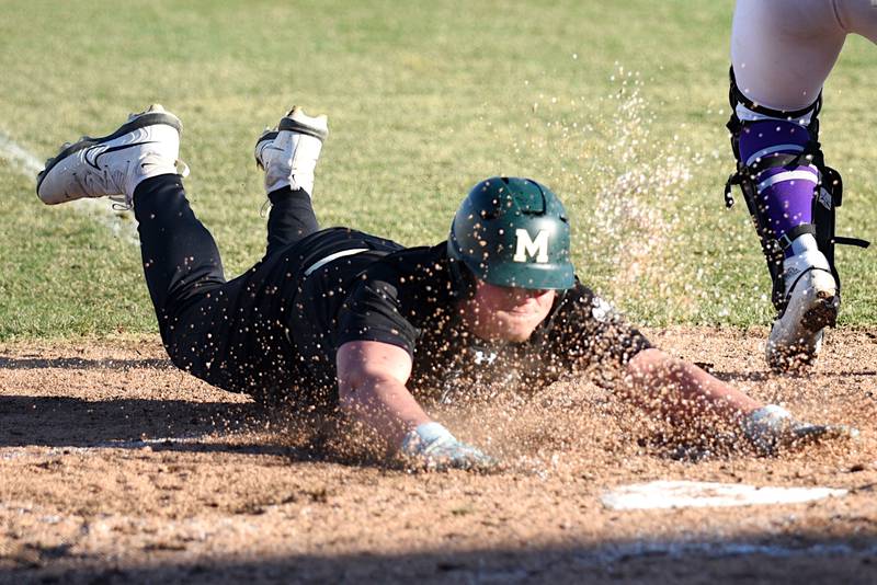 Bishop McNamara's Max Rohr dives into home plate to score a run during the Fightin' Irish's home game against Wilmington Monday, March 17, 2025.