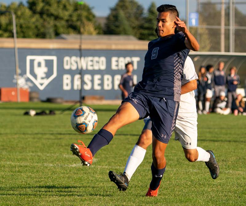 Oswego East's Dupablo Parodis-Yu (9) plays the ball against Oswego during a soccer match at Oswego East High School on Monday, Sep 26, 2022.