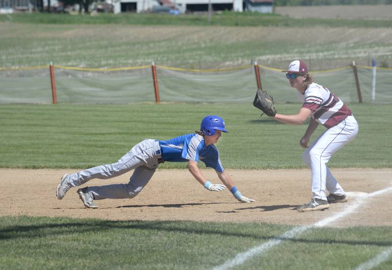 Newman's Garret Matznick dives back to first base during the 1A Pearl City Sectional championship on Saturday, May 27.