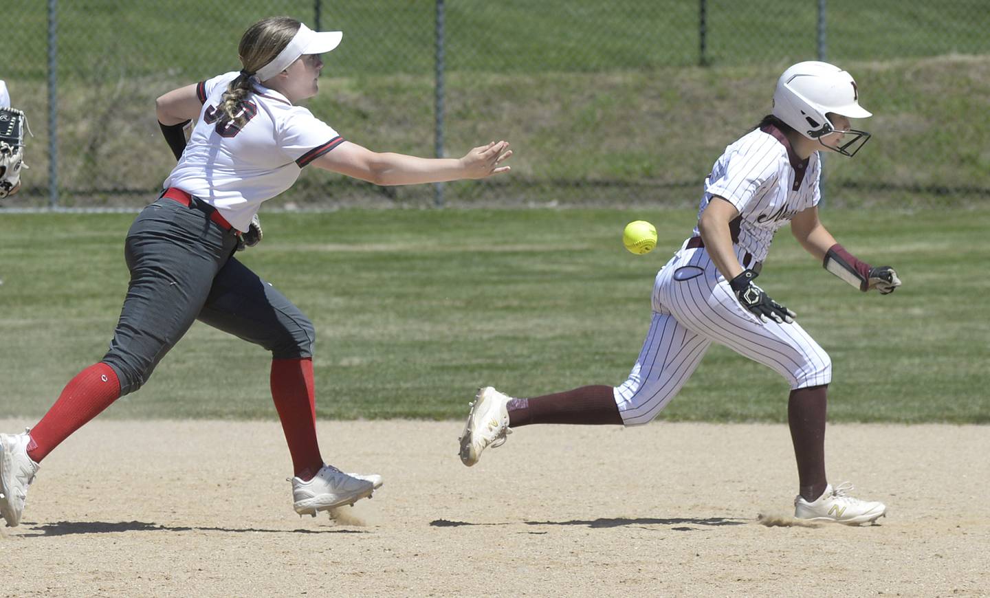 Ottawa’s Aubrey Sullivan (30) flips the ball as Morris baserunner Elaina Vidales tries to escape a rundown Saturday, May 25, 2024, at Ottawa's King Field.