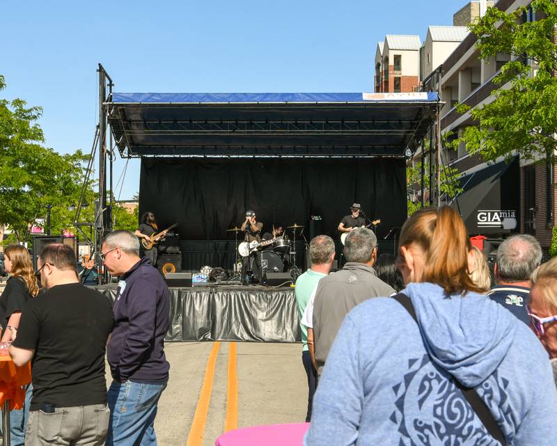 Community members listen to the band Reception on Saturday May 31, 2025, during the Elmhurst Summer Kick Off Party held at City Centre Fountain Plaza in Elmhurst.