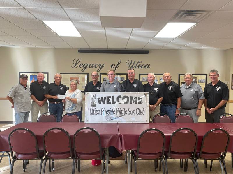 Members of the Utica Fireside White Sox Club recently presented a $1,500 donation to Helen Maurice (fourth from left), administrative assistant, Lighted Way. Since 2007, the club has raised and donated $55,100 to assist local charities.