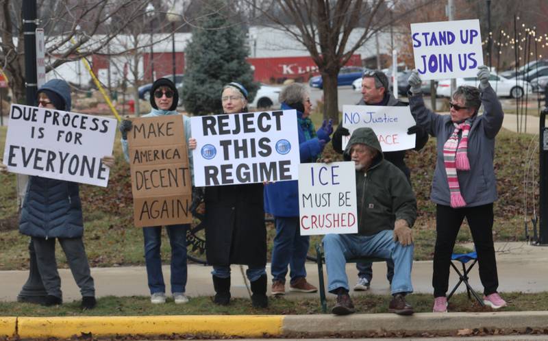 Protesters hold signs during a "ICE Out For Good" protest on Saturday, Jan. 10, 2026 at Rotary Park in Princeton. The Bureau County Democrats organized the event. About two-dozen protesters gathered to protest the ICE officer who shot and killed Renee Nicole Good in Minneapolis on Jan. 7.