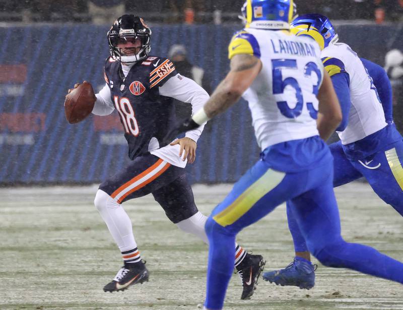 Chicago Bears quarterback Caleb Williams rolls away from the Los Angeles Rams pass rush Sunday, Jan. 18, 2026, during their NFC divisional playoff matchup at Soldier Field in Chicago.