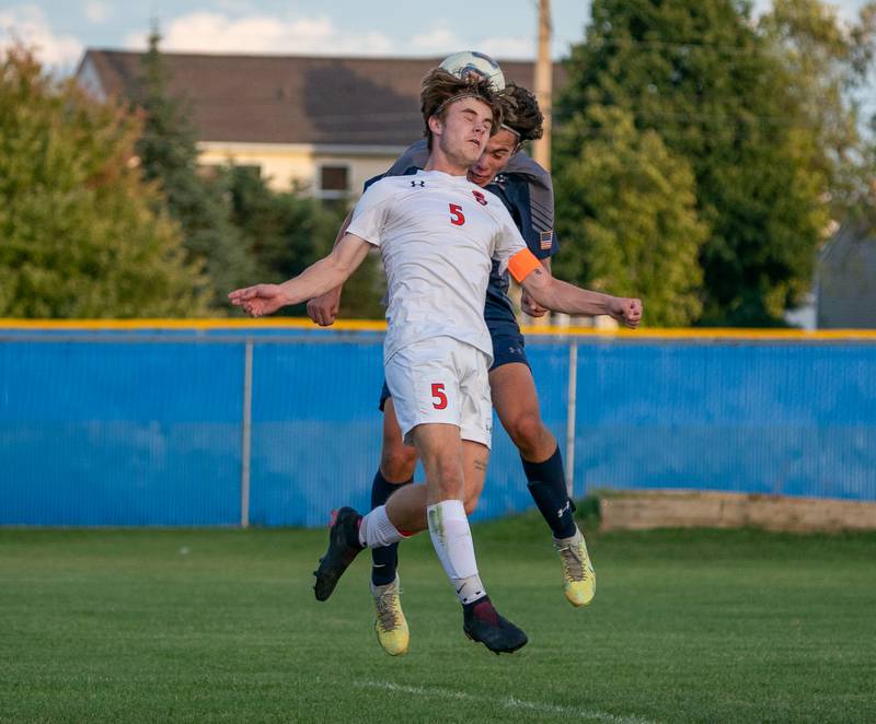 Oswego East's Josh Lopez (26) heads the ball for a goal against Oswego’s Joseph Walters (5) during a soccer match at Oswego East High School on Monday, Sep 26, 2022.