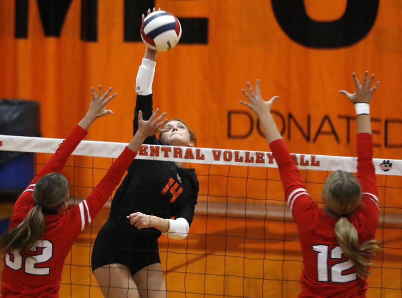 Crystal Lake Central's Jordyn Johnson hits the ball between Huntley's Izzy Whitehouse (left) and Summer Massow (right) during a Fox Valley Conference volleyball match on Tuesday,Aug. 26, 2025, at Crystal Lake Central High School.