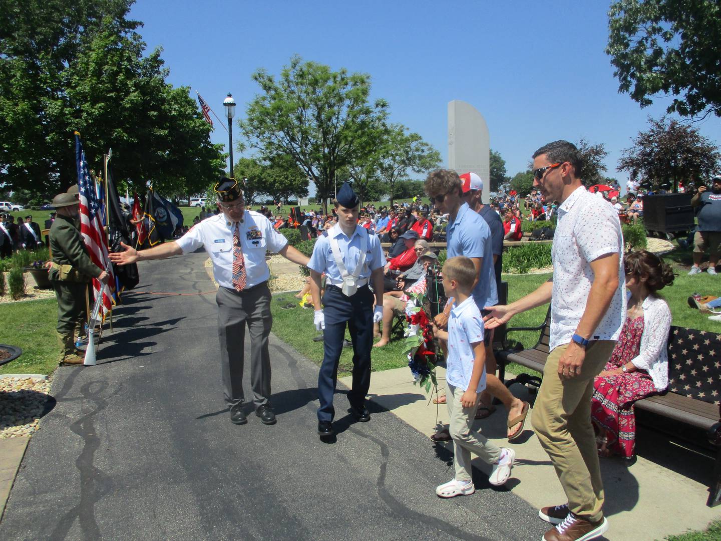 The Schwab family brings a wreath to the Tribute Memorial at Settlers' Park in Plainfield during Memorial Day services on Monday. Helen Schwab, who died in November and lost her son, Jeff, to a peacetime military death in 1984, was instrumental in the creation of the memorial. May 25, 2026