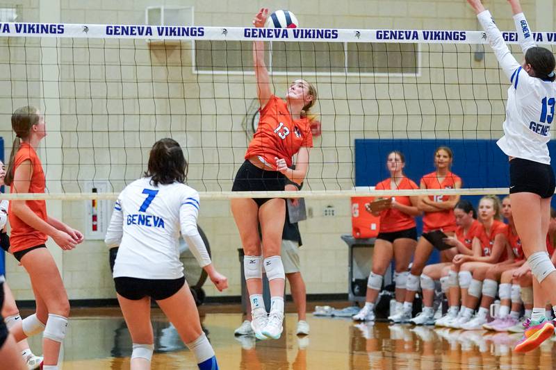 Wheaton Warrenville South's Alison Coyne (13) goes up for a kill against Geneva during a DuKane Conference match in Geneva on Tuesday, Sept. 16, 2025.