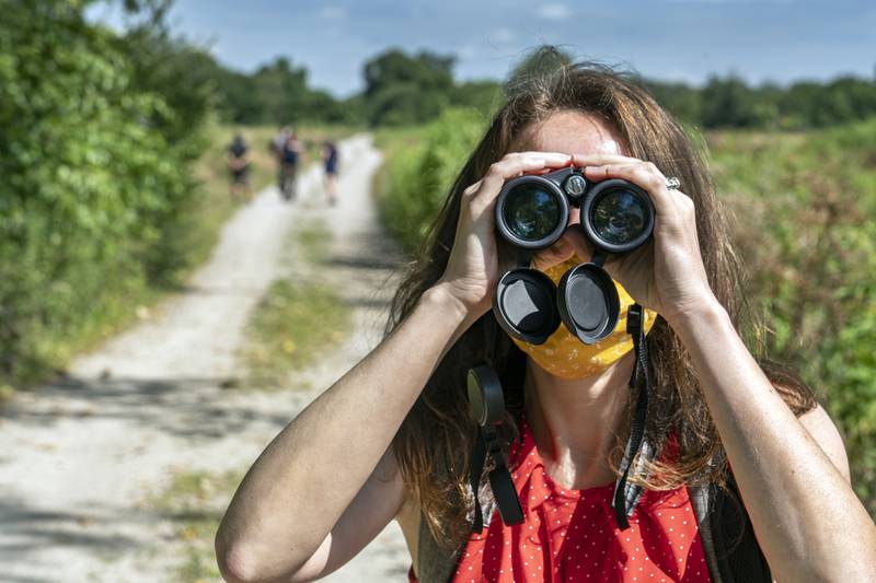 Catherine Game looks for grassland birds along the Henslow Trail at Midewin National Tallgrass Prairie. The public is invited to provide input for a plan for the future of birdwatching and other recreational activities at Midewin National Tallgrass Prairie on Tuesday, March 22, 2022.