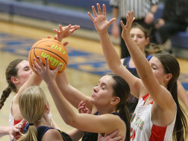 Somonauk's Emma Elder grabs a rebound over L-P's Drew Depenbrock and teammate Madilyn Knowles during the Tim Humes Breakout Tournament on Friday, Nov. 22, 2024 at Somonauk High school.