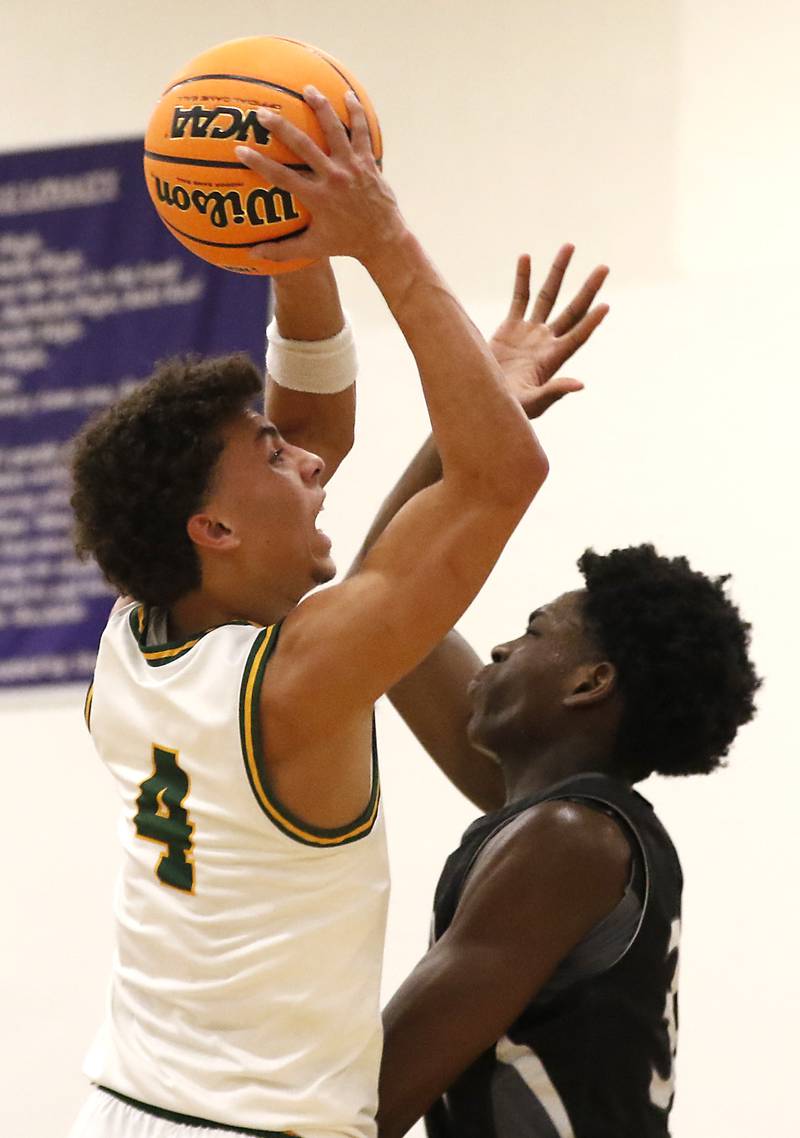 Crystal Lake South's AJ Demirov drives to the basket against Kaneland's Jeffrey Hassan during the IHSA Class 3A Rochelle Sectional championship basketball game on Friday, March 7, 2025, at Rochelle High School.