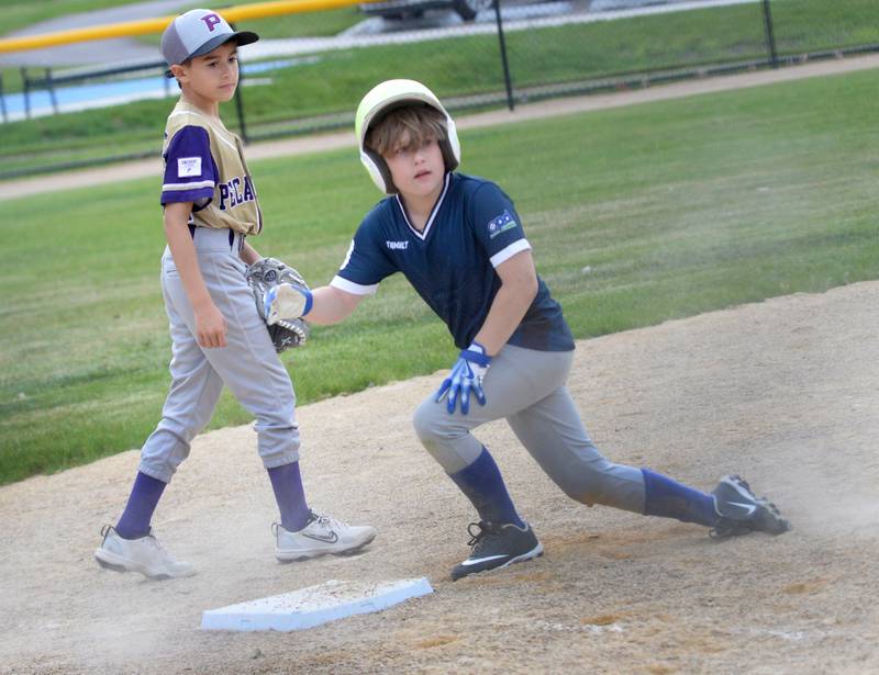 Hewyt Westfall steals third base during one of the games on the new baseball diamond during the grand opening event at the Park East Inland Side recreation area's ball field on Monday, May 18, 2026.