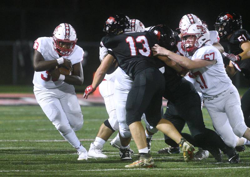 South Elgin's Darrion Thurman, left, finds some running room during Friday’s football game against Glenbard East in Lombard.