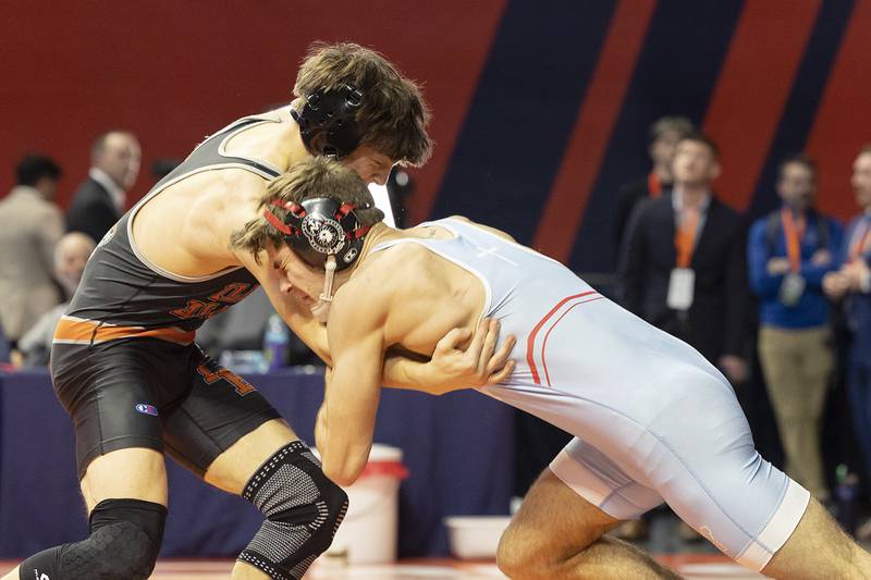 Marian Central’s Vance Williams shoves Illini Bluff’s Jackson Carroll back in the 150 pound weight class of the 1A state individual wrestling finals Saturday, Feb. 22, 2025, at State Farm Center in Champaign.