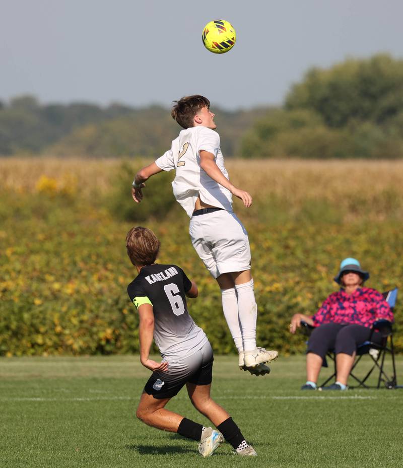 Sycamore's Andre Crouch goes up high over Kaneland's Noah McKittrick to head the ball during their game Wednesday, Sept. 16, 2025, at Kaneland High School in Maple Park.