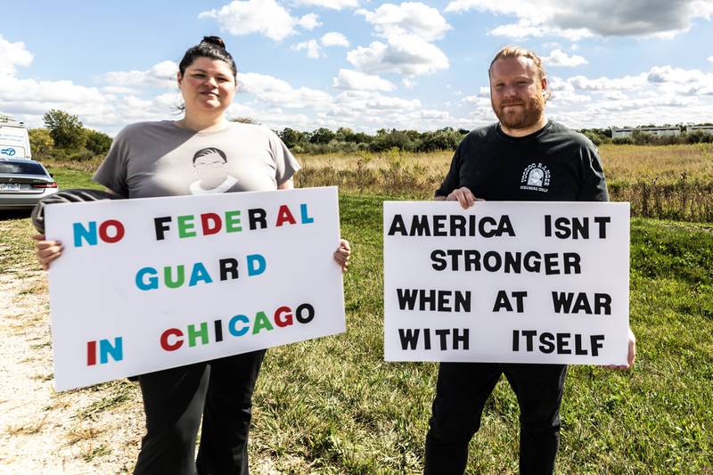 Andrea Villarreal and Brandon Shrader, of Northwest Indiana, protest at the Joliet Local Training Area site for the Illinois National Guard at 20612 Arsenal Road in Elwood on Wednesday, Oct. 8, 2025.