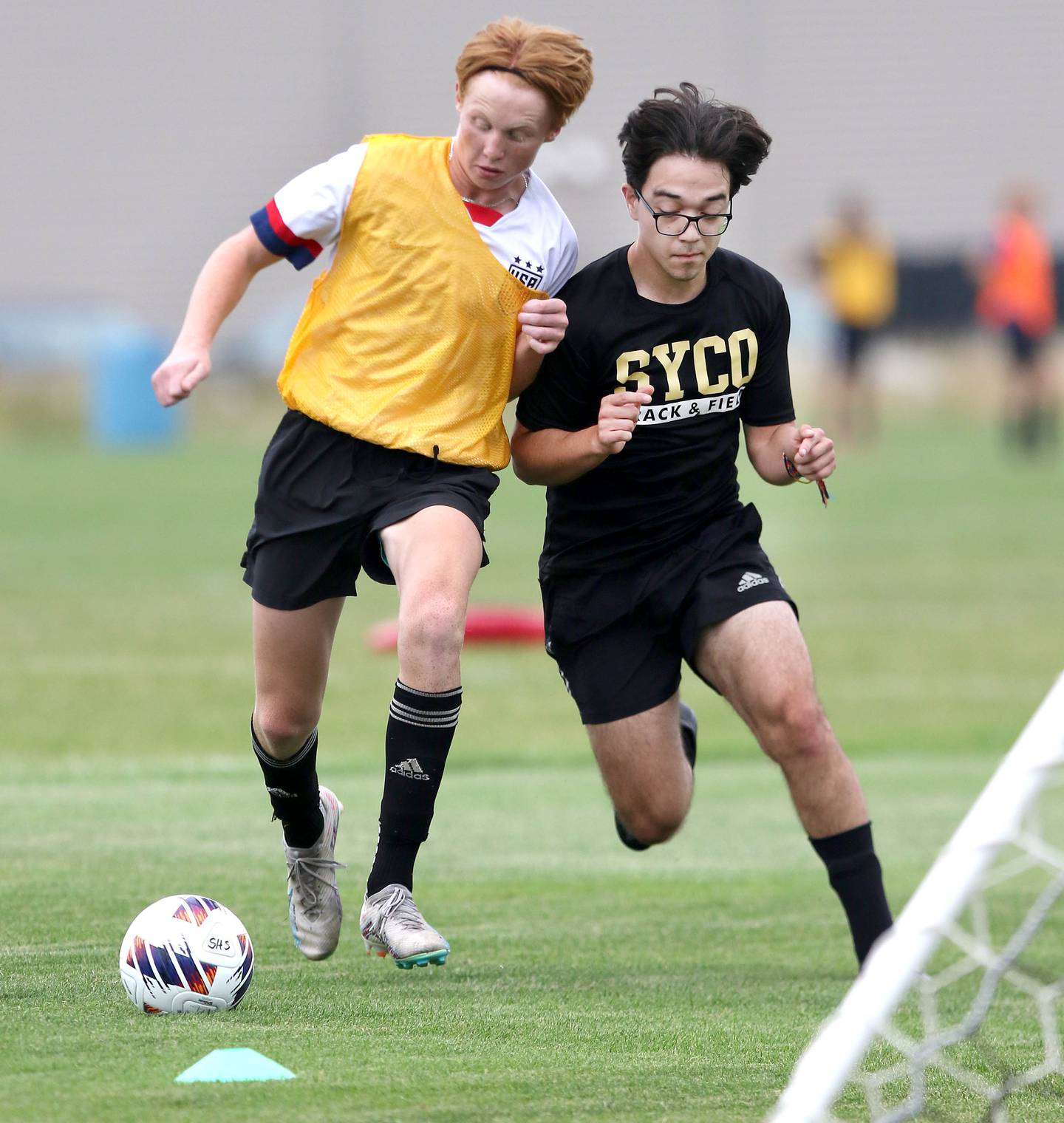 Sycamore’s Jameson Carl (left) takes the ball towards the goal during a scrimmage at practice Wednesday, August 9, 2023, at Sycamore High School.
