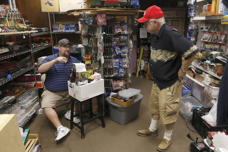 Matt Drennan, owner of M.D. Trains, talks with model train enthusiast Frank Grzetic at his store at 130 Cass St. in Woodstock. The model train and die-cast car shop has been fixture on the Woodstock Square for a few years and draws visitors in to check out the rotating display of trains in the front window.