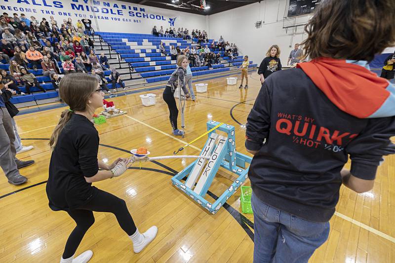 Lilly Saldino, a seventh grader at Rock Falls Middle School, pulls back to fire during competition Thursday, Dec. 8, 2022.