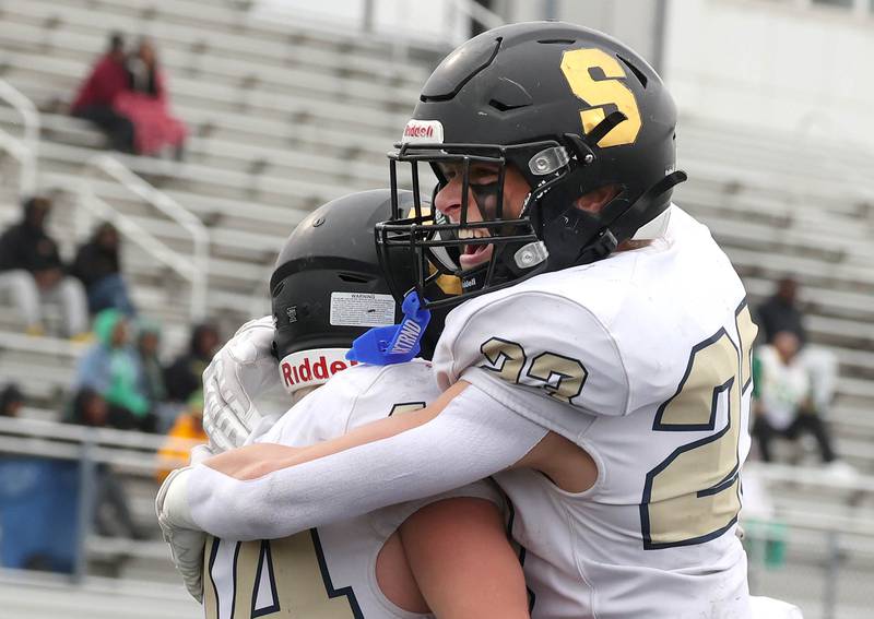 Sycamore's Cooper Bode (left) celebrates after scoring a touchdown with teammate Dylan Hodges follows the blocking of Cristian Spartz Saturday, Nov. 9, 2024 during their Class 5A second-round playoff game against Westinghouse at Knute Rockne Stadium in Chicago.