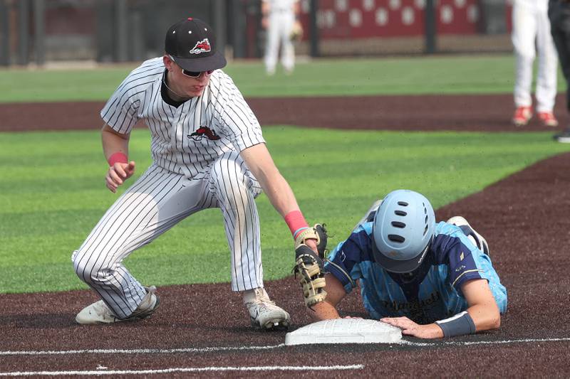 Marquette's Caden Durdan dives back safely as Fulton's Jacob Huisenga applies the tag on a pickoff attempt Monday, June 2, 2025, during their Class 1A supersectional game at Northern Illinois University in DeKalb.