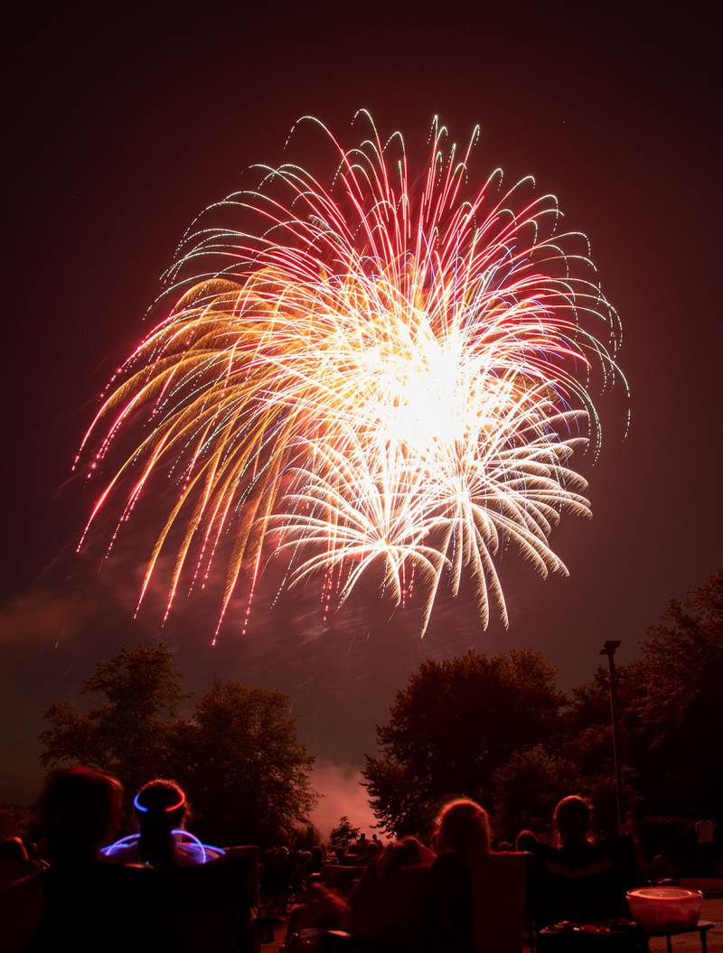 Attendees gather to watch fireworks during North Aurora's annual Independence Day celebration  at Riverfront Park in North Aurora on Monday, July 3, 2023.