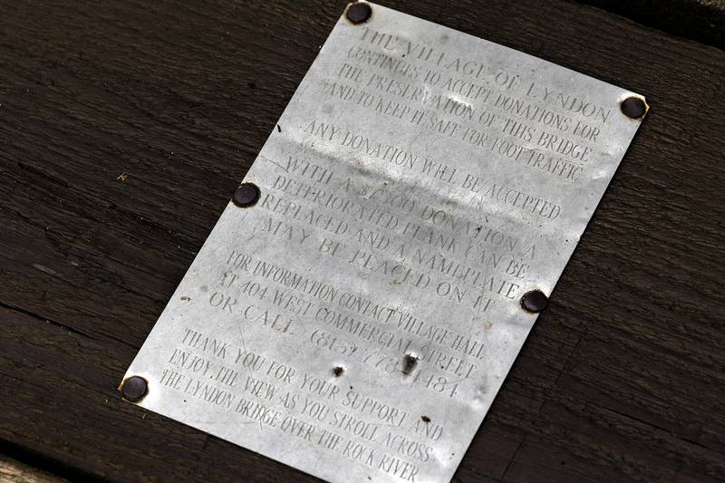 An informational plaque is seen on the Lyndon Bridge Thursday, July 30, 2025. Cost has changed from $75 to $100 for the repair and name plate.