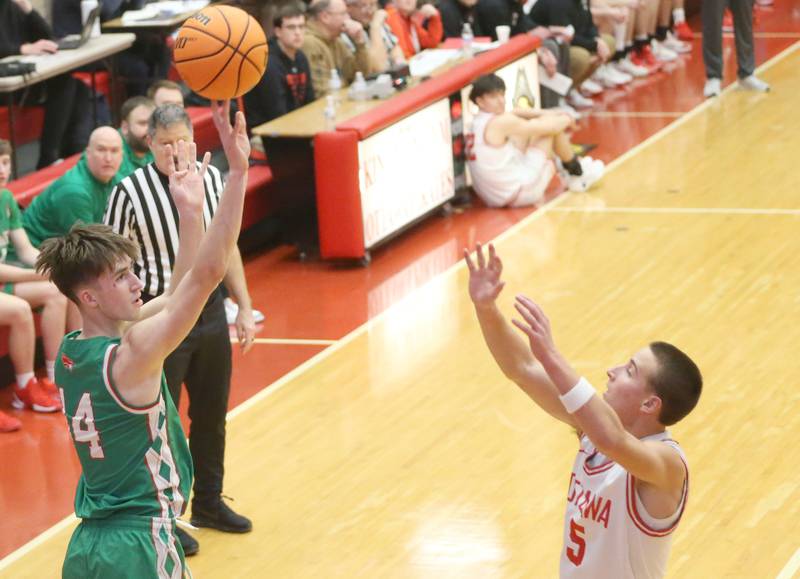 L-P's Wyatt Kilday lets go of a three-point shot over Ottawa's Rory Moore on Friday, Feb. 6, 2026 in Kingman Gymnasium at Ottawa High School.